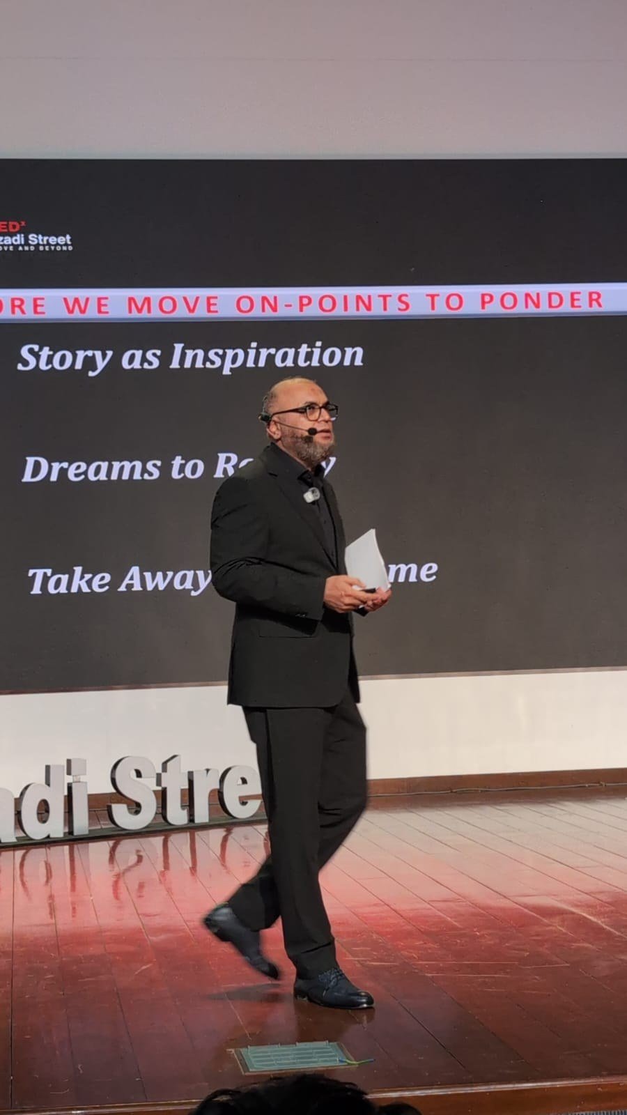 Masood Hassan Qureshi speaking on stage
